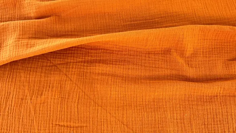 material-muselina-orange-melissas Material muselină organică portocalie Melissas – textură naturală și respirabilă